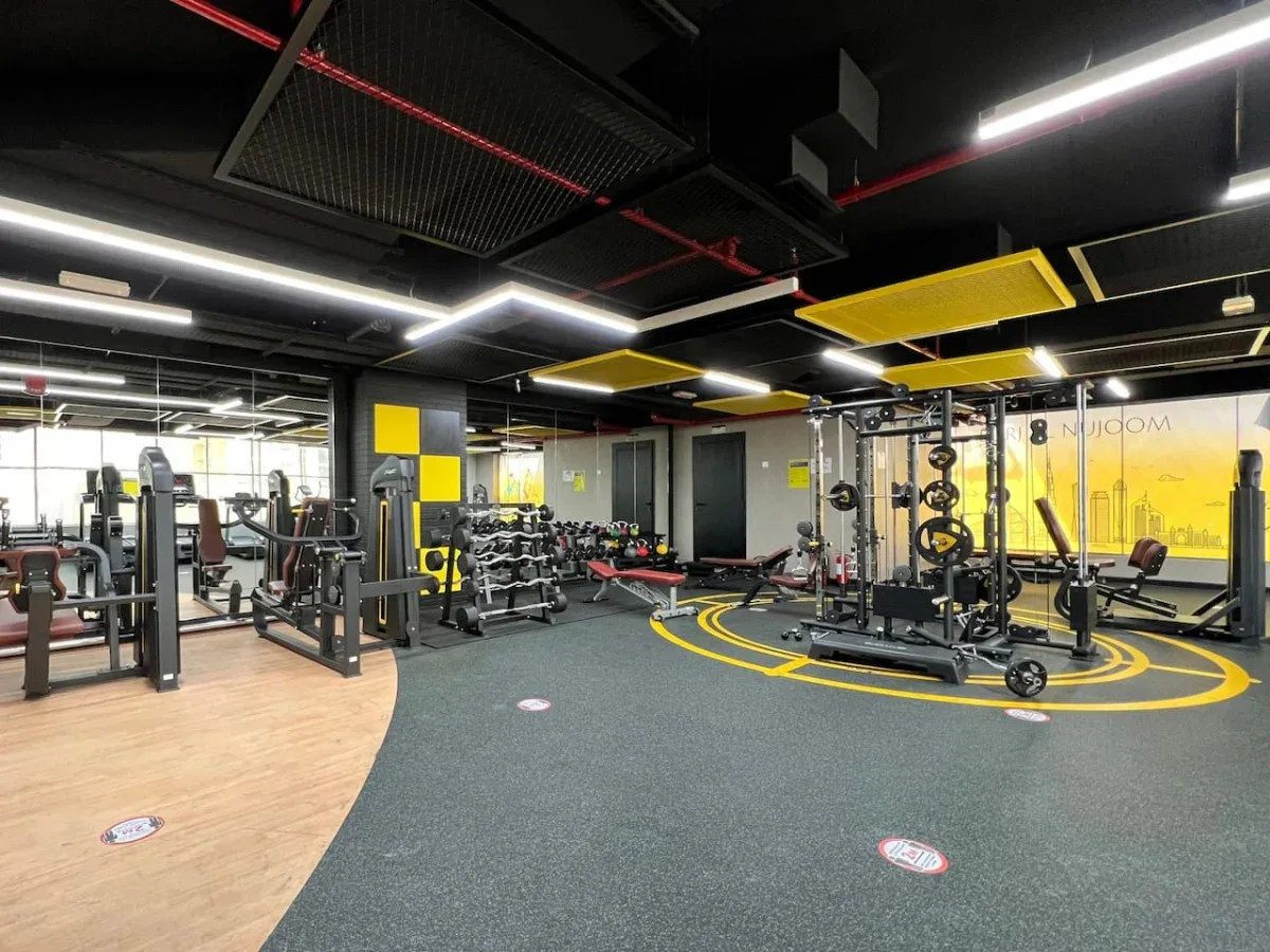 A fitness room with exercise machines and weight-training equipment.