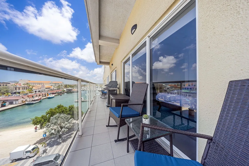 A scenic waterfront retreat awaits you on this balcony, where turquoise canals and coastal charm create the perfect backdrop for your morning coffee or sunset relaxation.