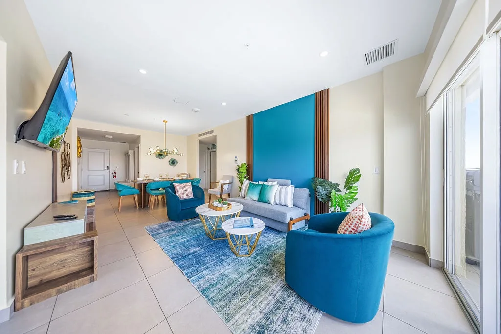 Unwind in your bright, airy living space where bold teal accents meet sleek modern style. Sink into plush seating, enjoy the flat-screen TV, and feel right at home in this thoughtfully designed retreat.