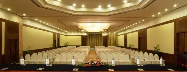 Salón de banquetes con mesas redondas y asientos dispuestos al estilo teatro