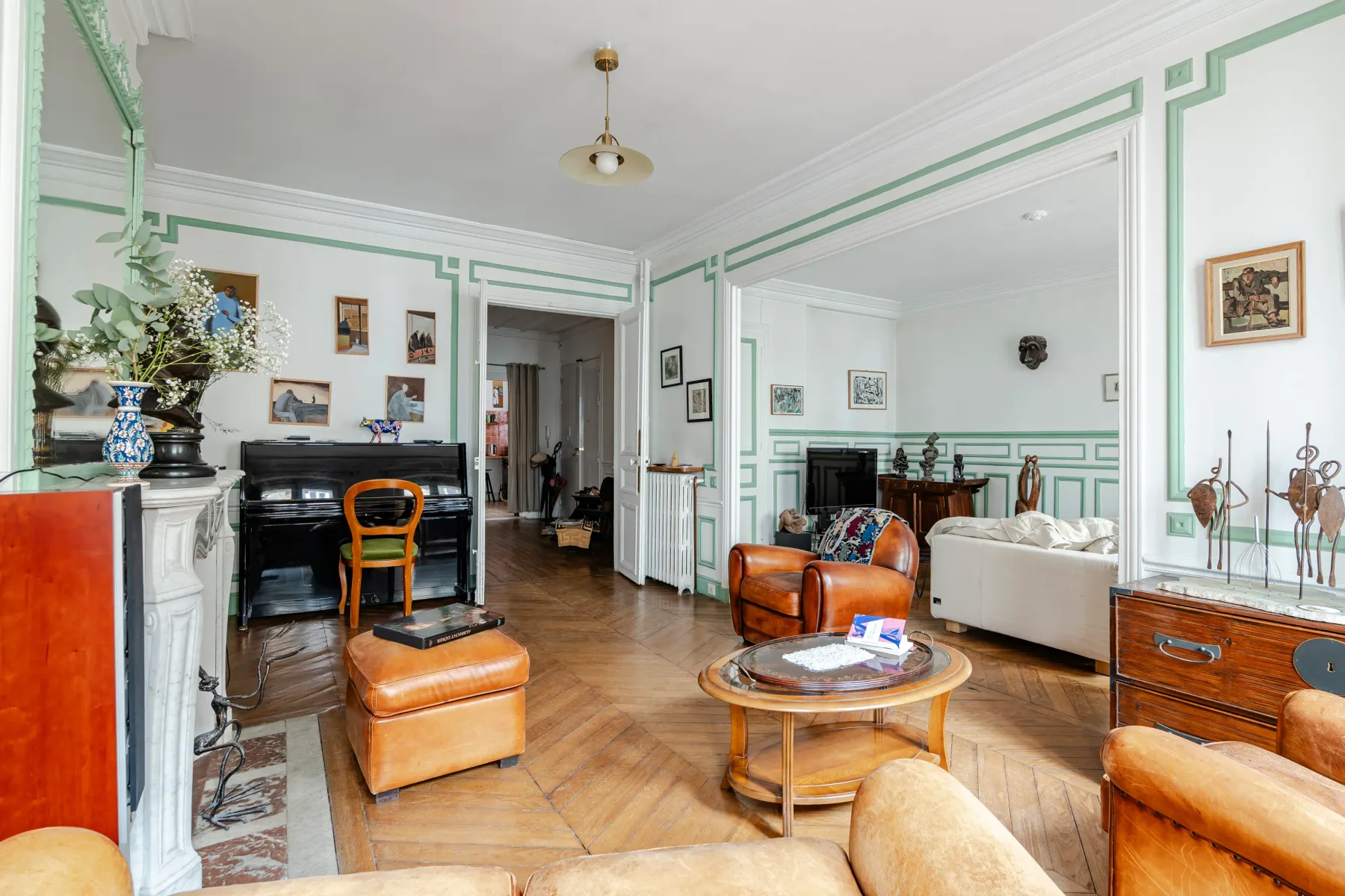 A spacious living room with seating, a coffee table, and a fireplace.