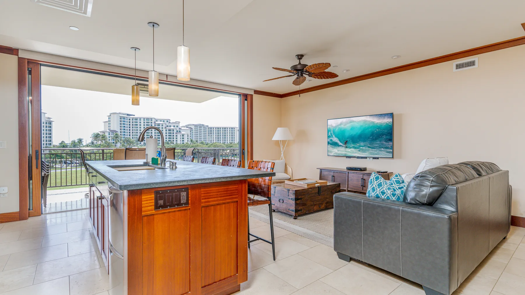 An open-plan living and kitchen area with a kitchen island and seating.