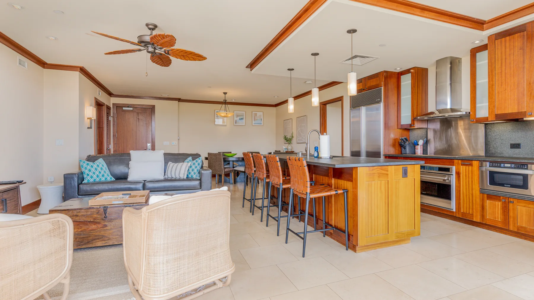 An open-plan kitchen and living area with a central island and seating.