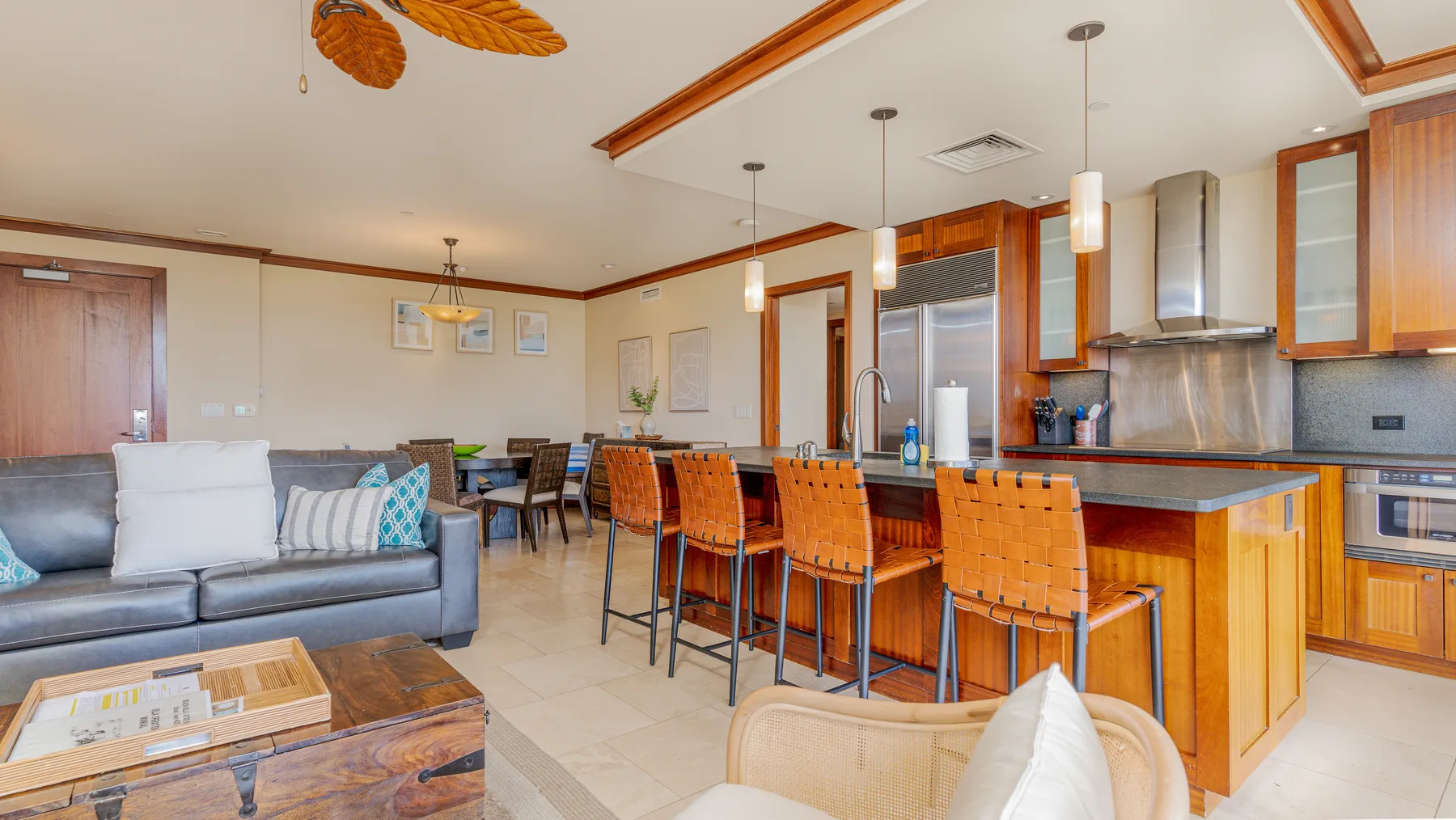 An open-plan living and dining area with a kitchen island and bar seating.