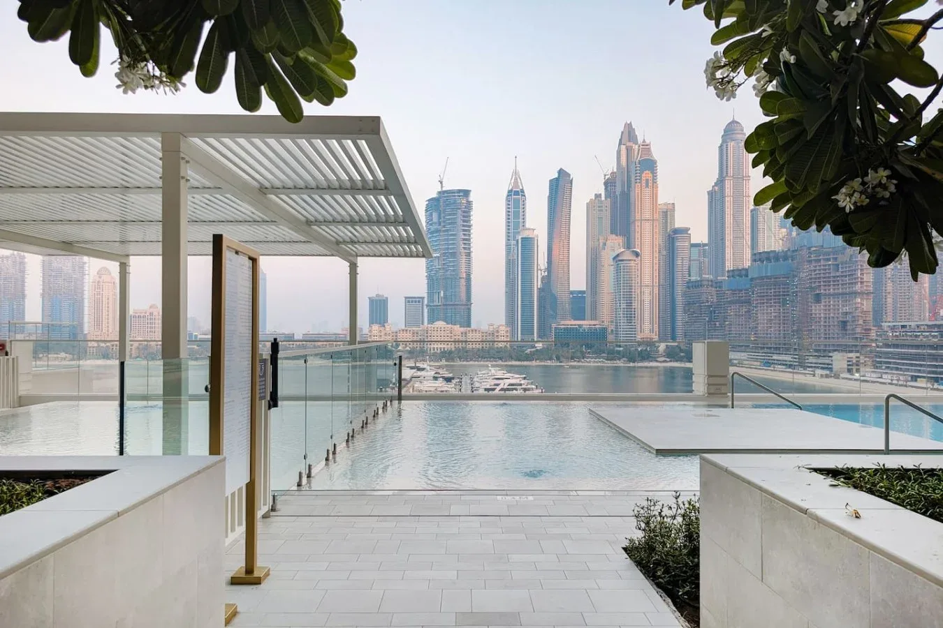 Una piscina en la azotea ofrece vistas al horizonte de la ciudad, junto a una zona cubierta.