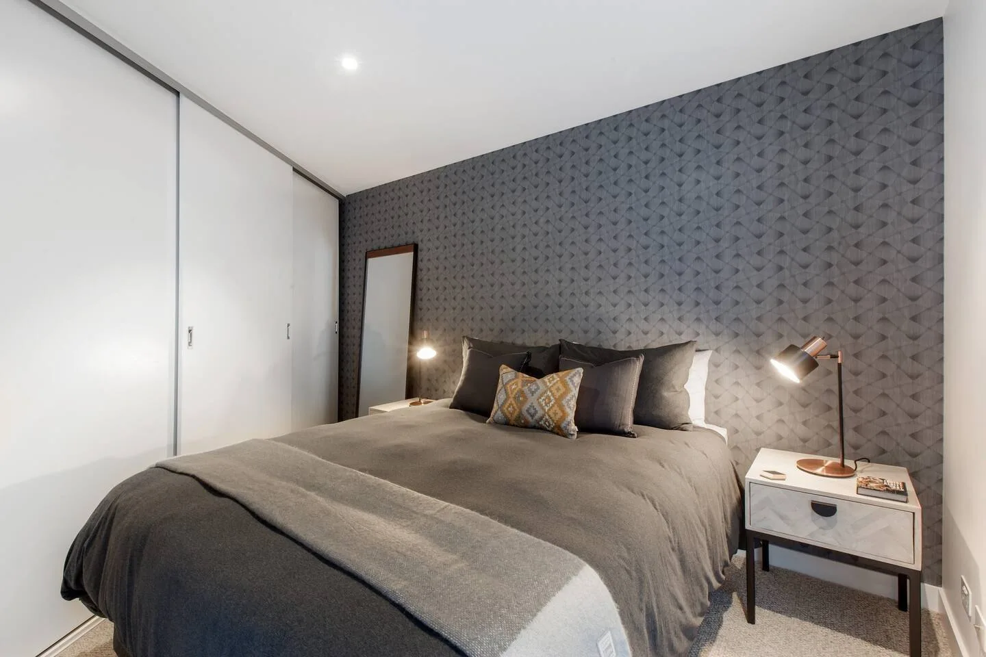Descansa en el dormitorio, con una cama queen vestida con ropa de cama suave y espacio de almacenamiento integrado para mantener todo cómodamente organizado durante tu estancia.