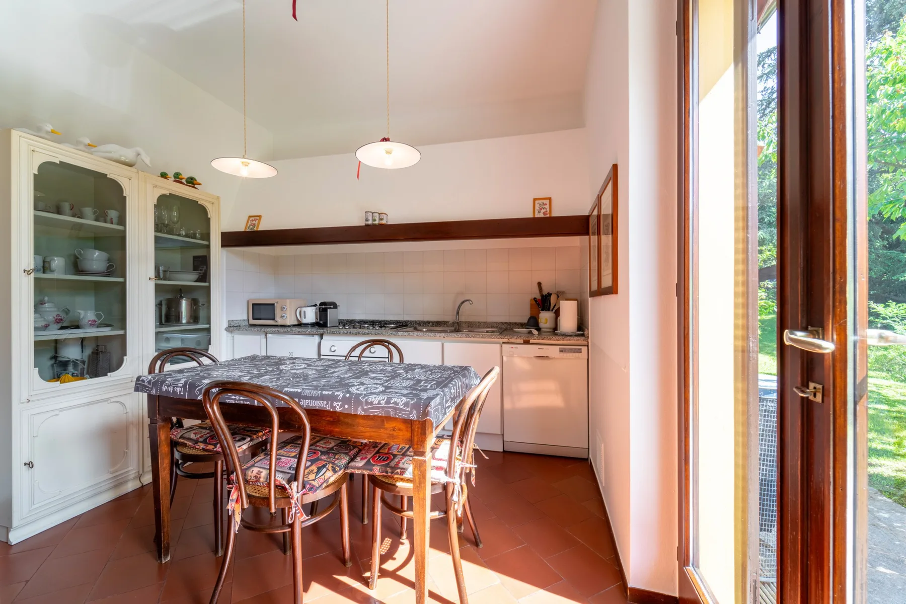 A dining area with a table and chairs beside a kitchen counter.
