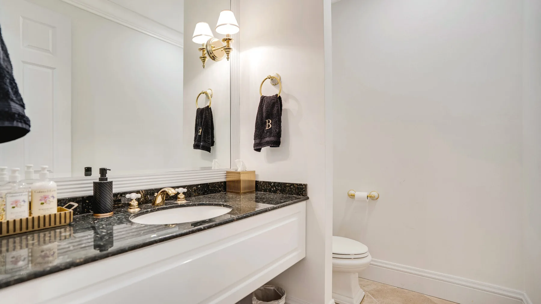 A bathroom vanity with a sink and toilet beside it.