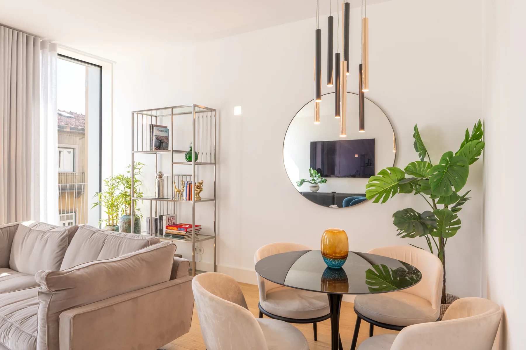 A bright living and dining area with seating around a glass table.