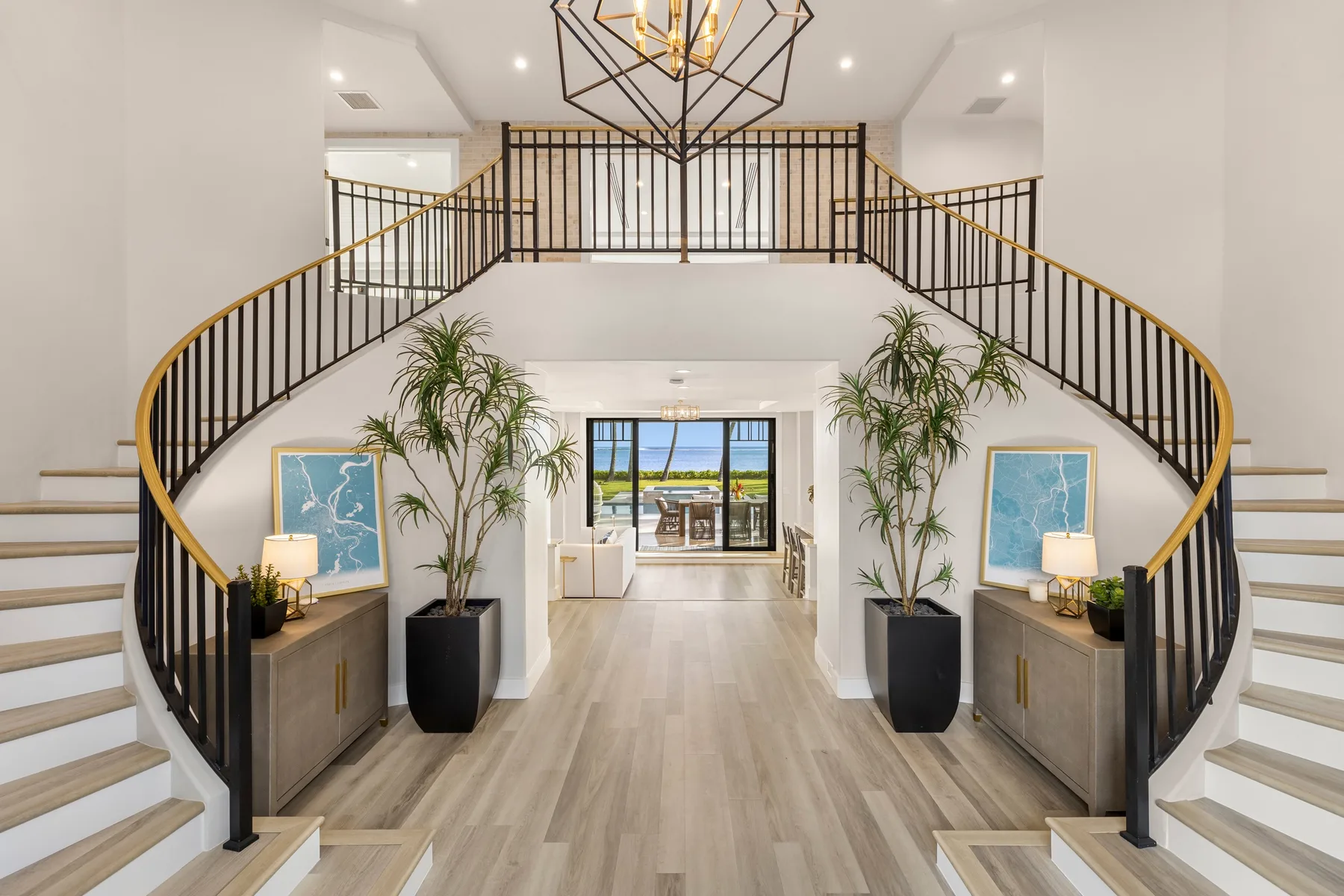A bright entry hall features a curved staircase and a view into the living area.