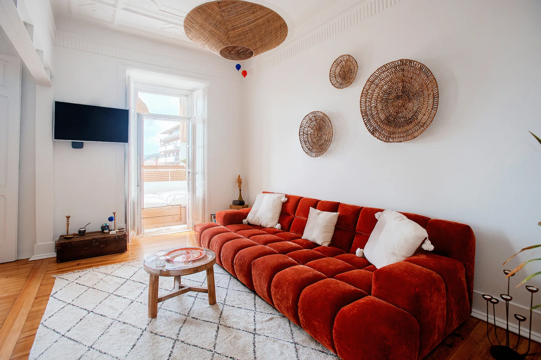A living room with red seating and a round coffee table.
