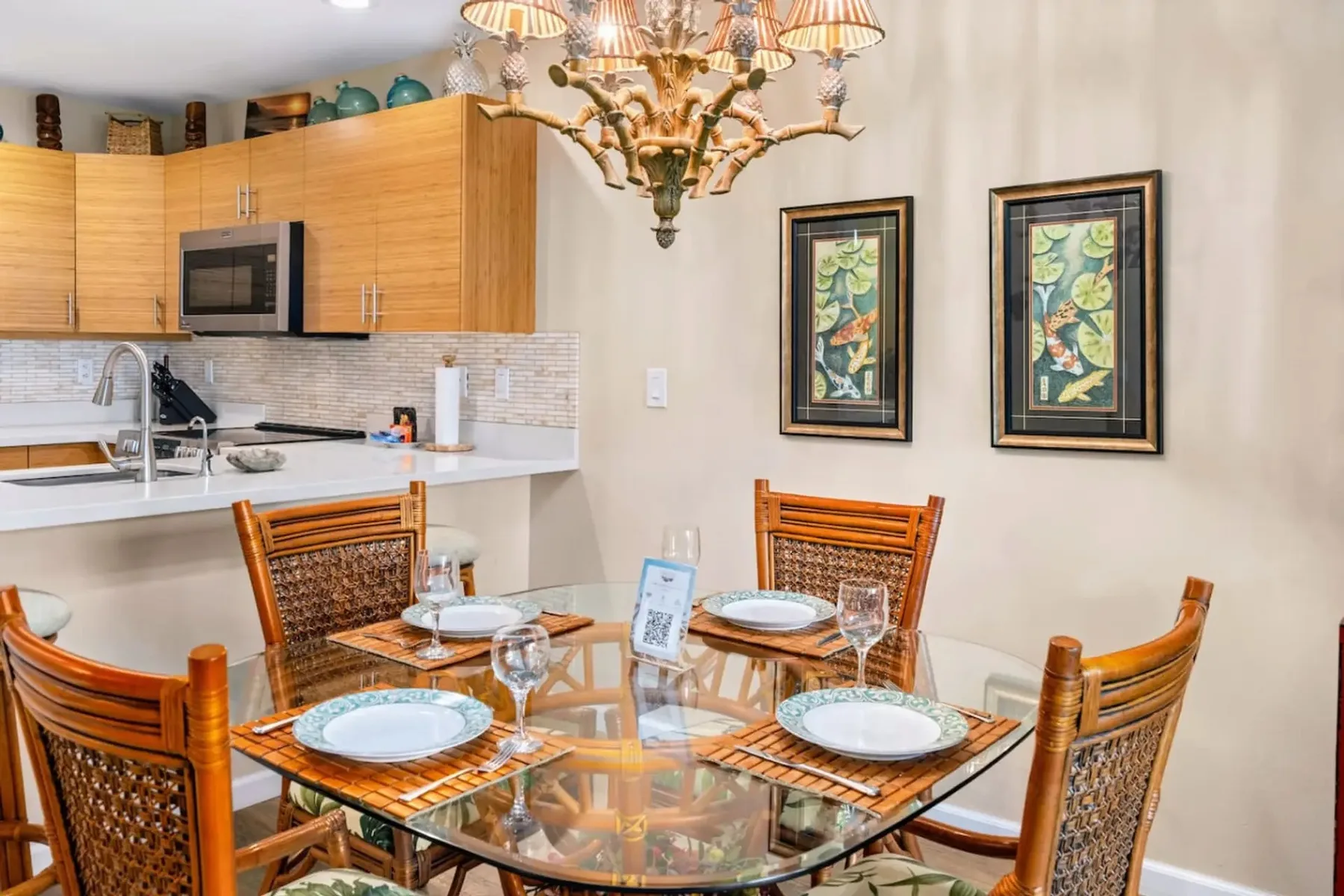 Comedor con mesa de vidrio y asientos de madera junto a la cocina.