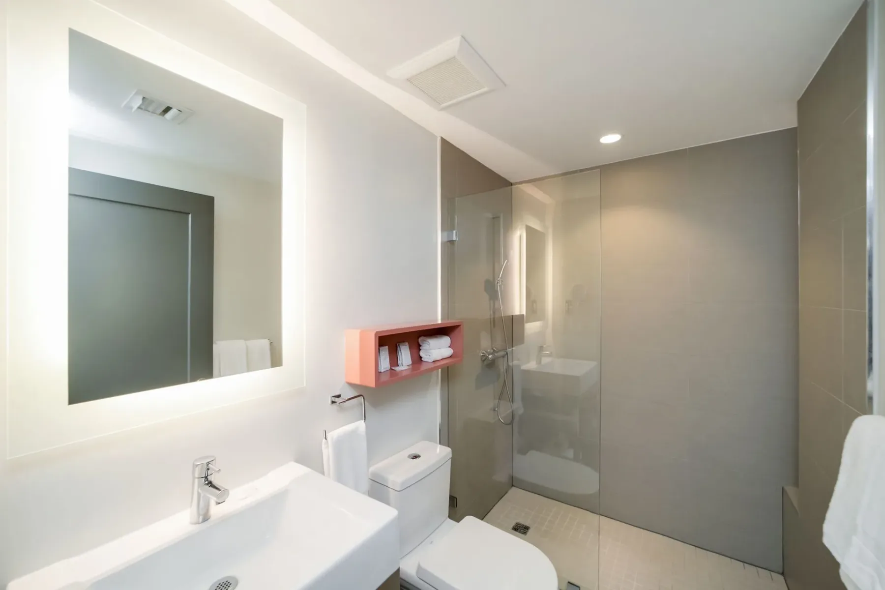 Bathroom with a white sink, toilet, and shower.