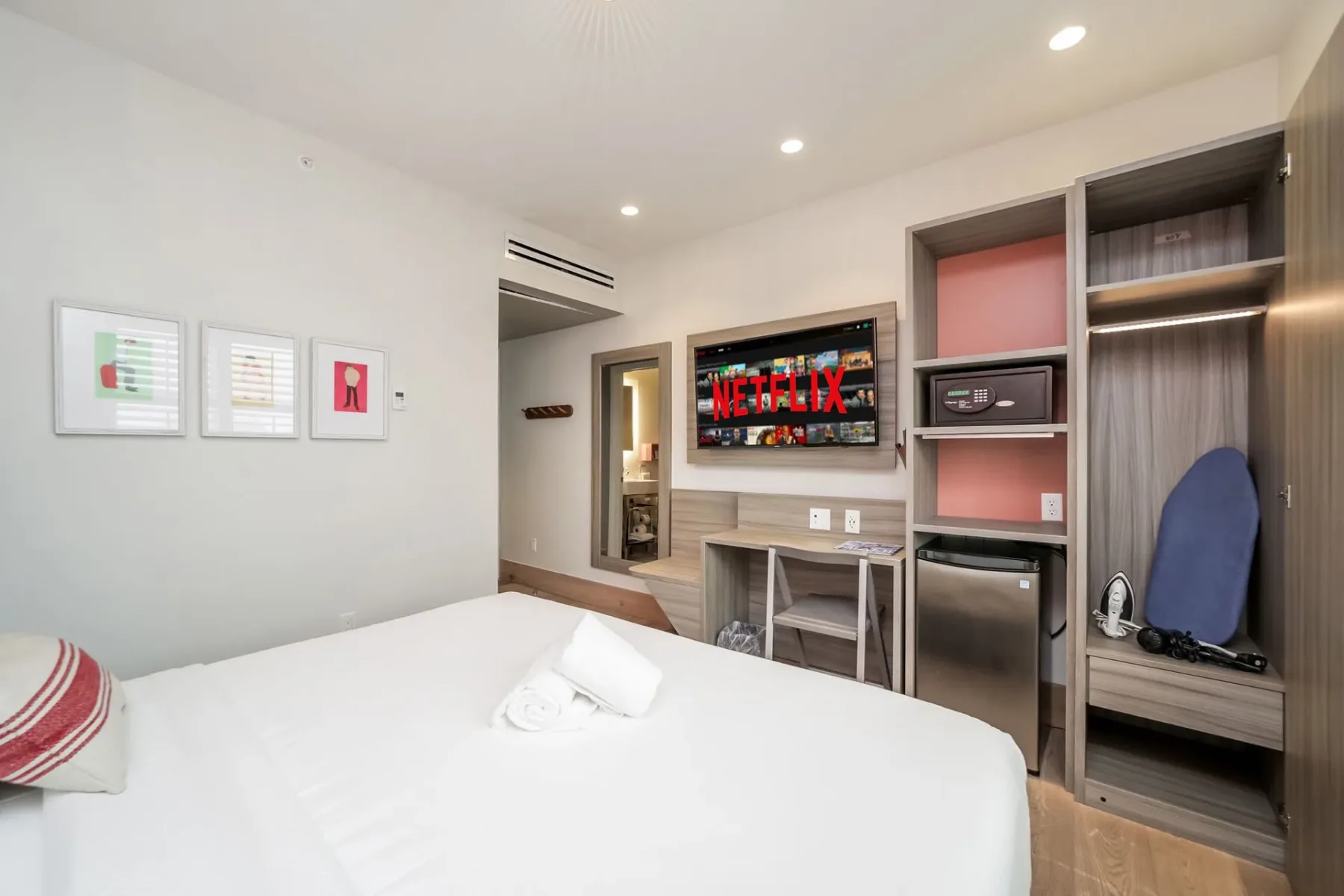 Serene Superior room with a bed, TV, closet, and small fridge.