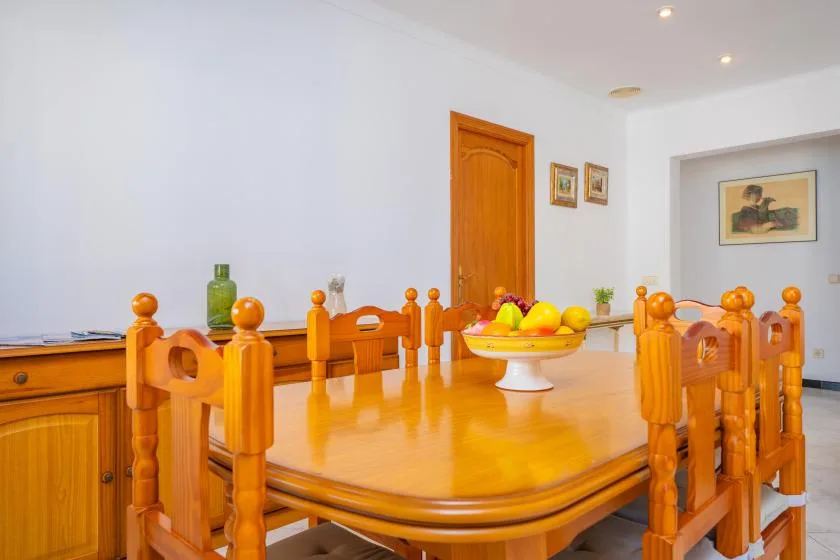 Dining room with a long wooden table and matching chairs.