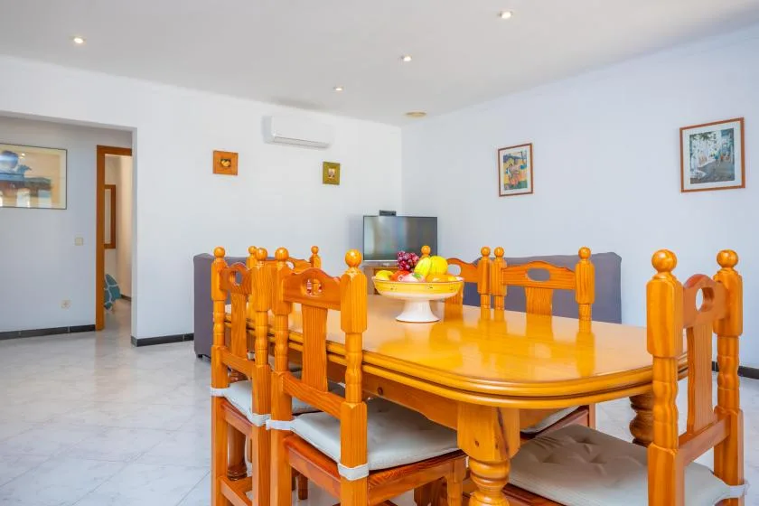 A dining area with a large wooden table and chairs.