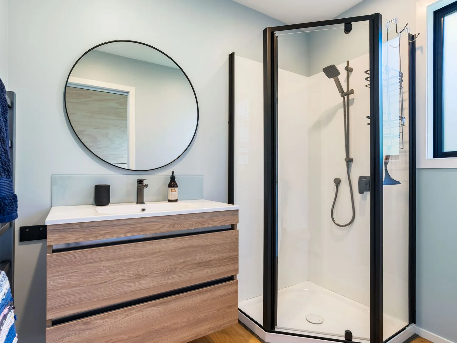 A bathroom with a shower and vanity at The Cove Escape - Cooks Beach