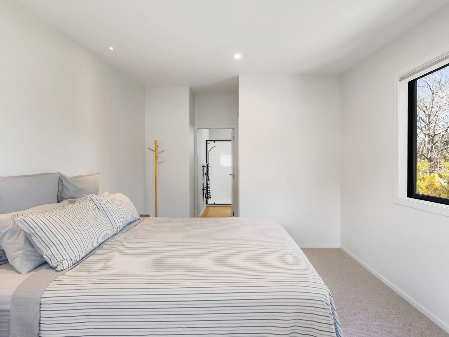 A bedroom with a bed and a window at The Cove Escape - Cooks Beach Holiday Home