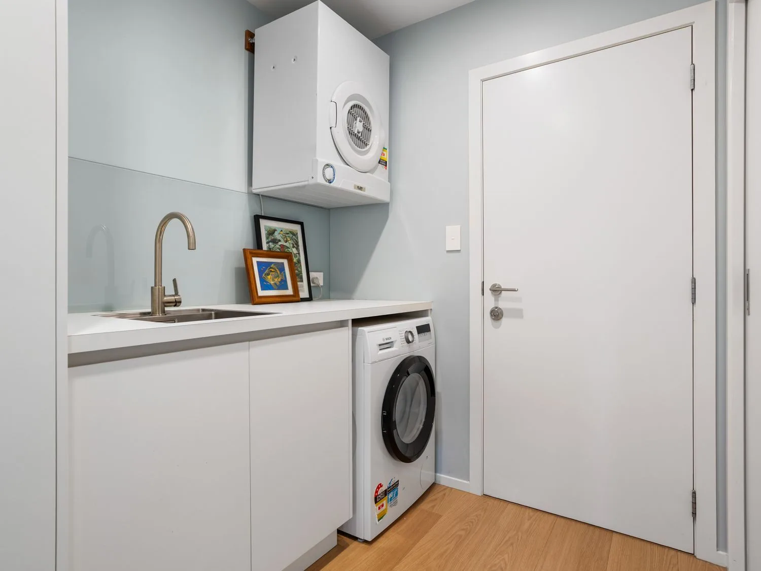 A laundry room with a washing machine and dryer at The Cove Escape - Cooks Beach