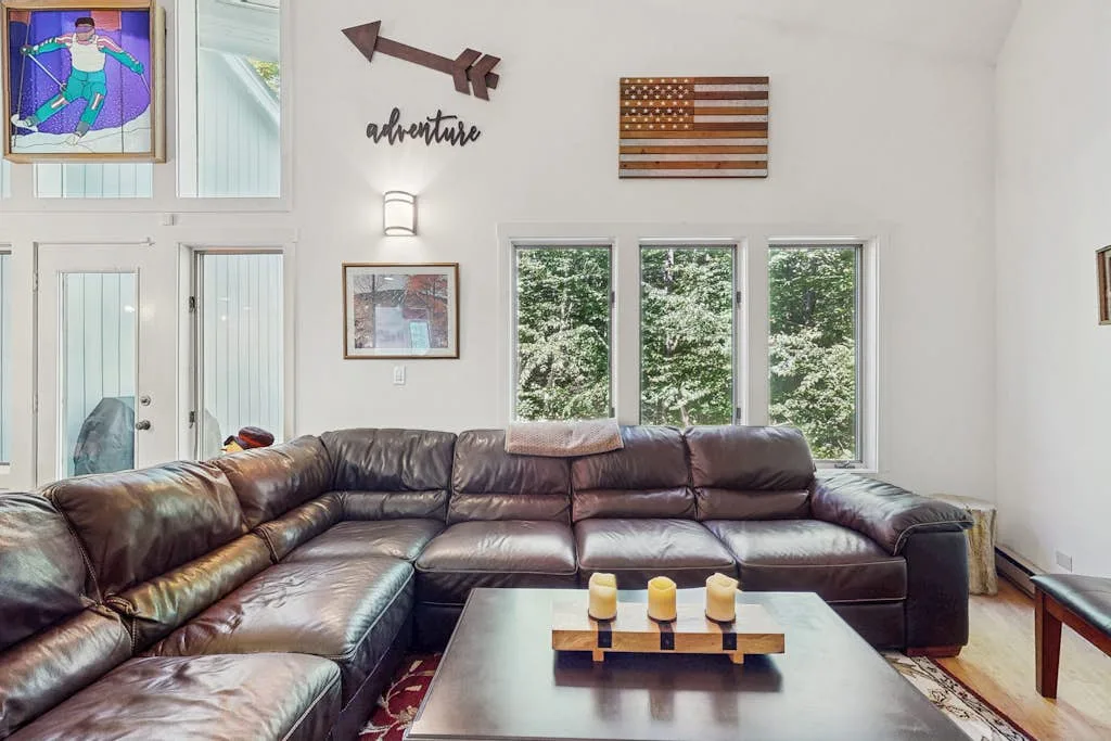 A bright living room has an L-shaped seating area facing a coffee table.