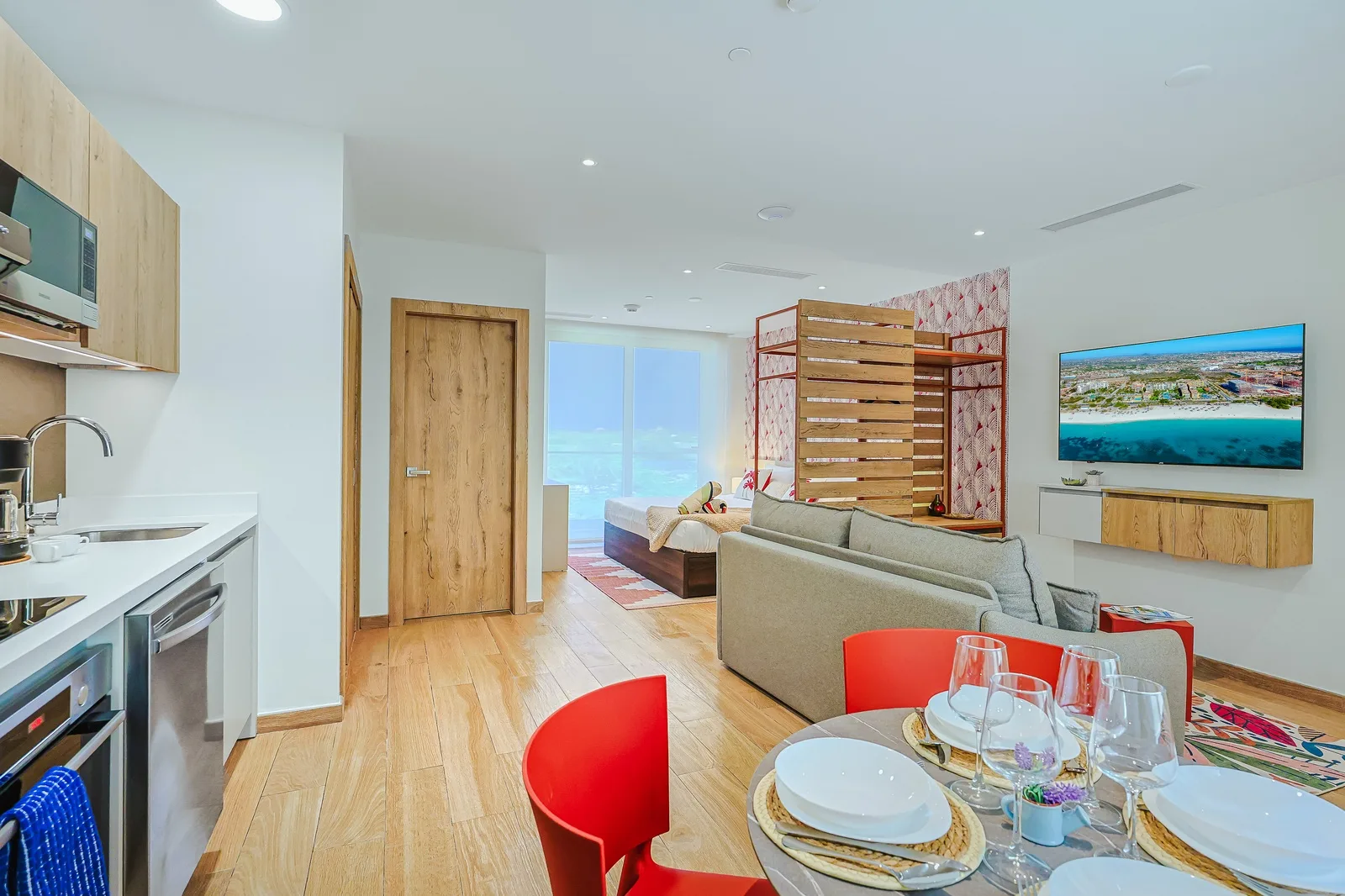 Step into your bright open-plan retreat where modern design meets coastal comfort. Stylish furnishings blend with warm wood tones, while natural light floods the space, creating a perfect relaxation sanctuary.