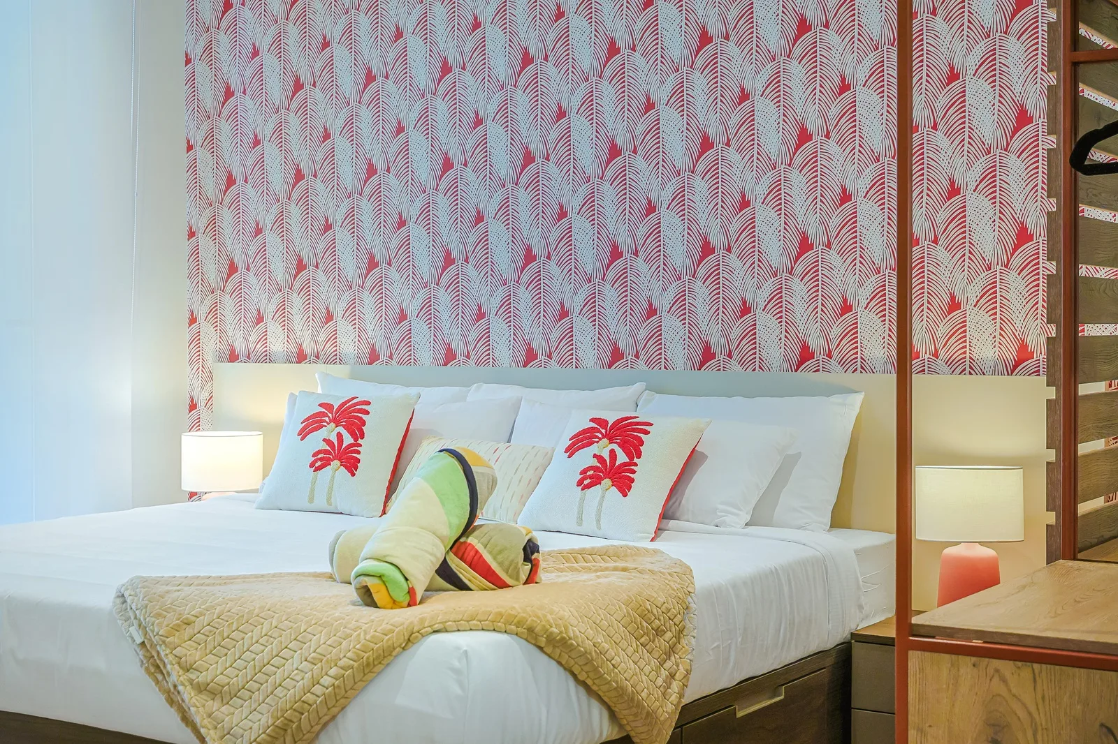 Your tropical escape awaits with vibrant décor, crisp white linens, and soft bedside lighting—designed for a restful getaway.