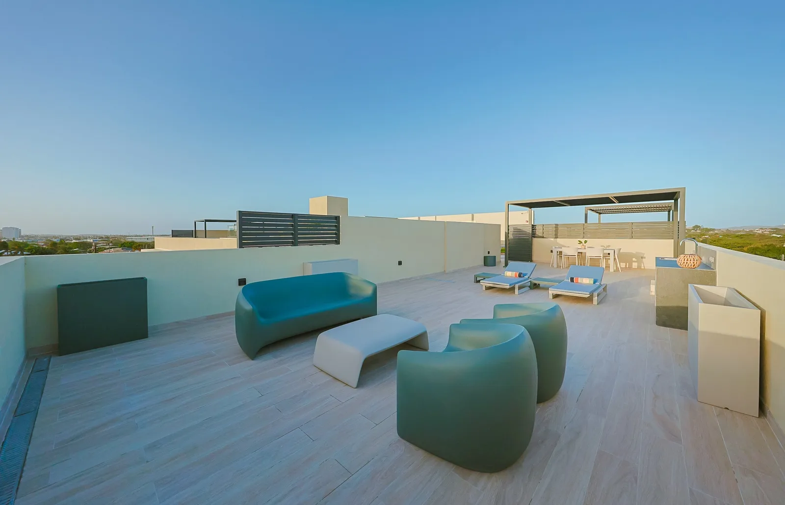 The modern rooftop terrace with sculptural loungers creates a stylish retreat where you can unwind, enjoy the fresh air, and take in the beautiful surroundings.