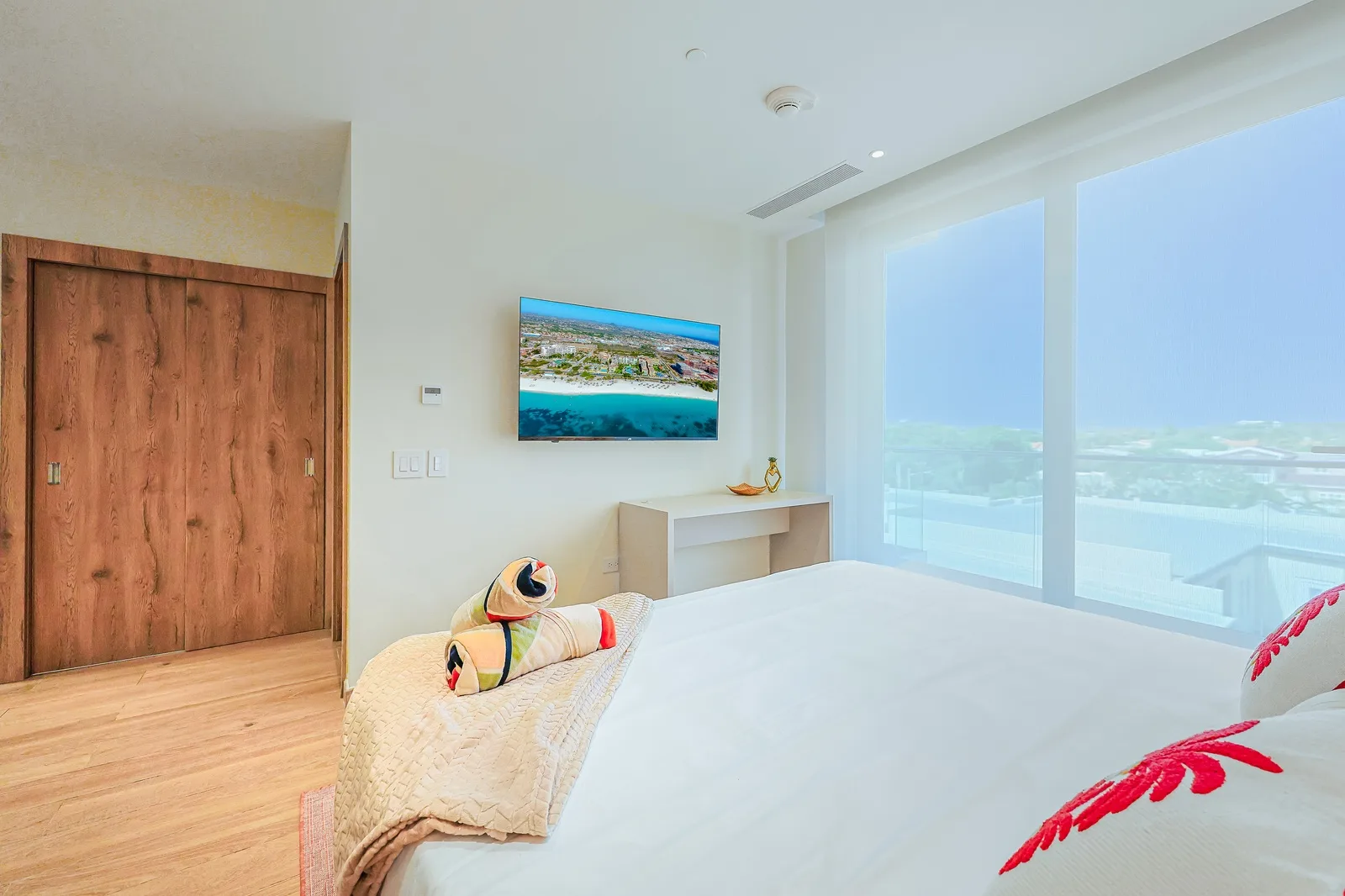 Wake up to bright, natural light streaming through floor-to-ceiling windows, framing peaceful views of the surrounding neighborhood. This serene bedroom offers crisp linens, modern comfort, and a calming ambiance perfect for your getaway.