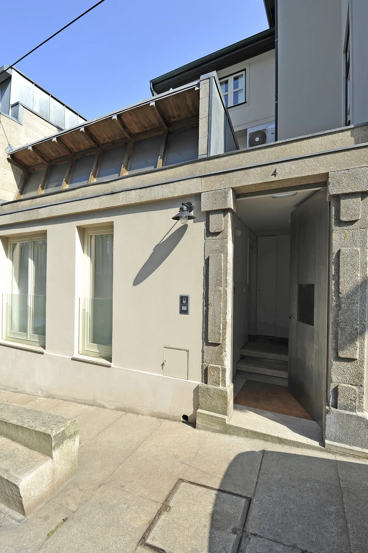 A building entrance with a recessed doorway and windows.