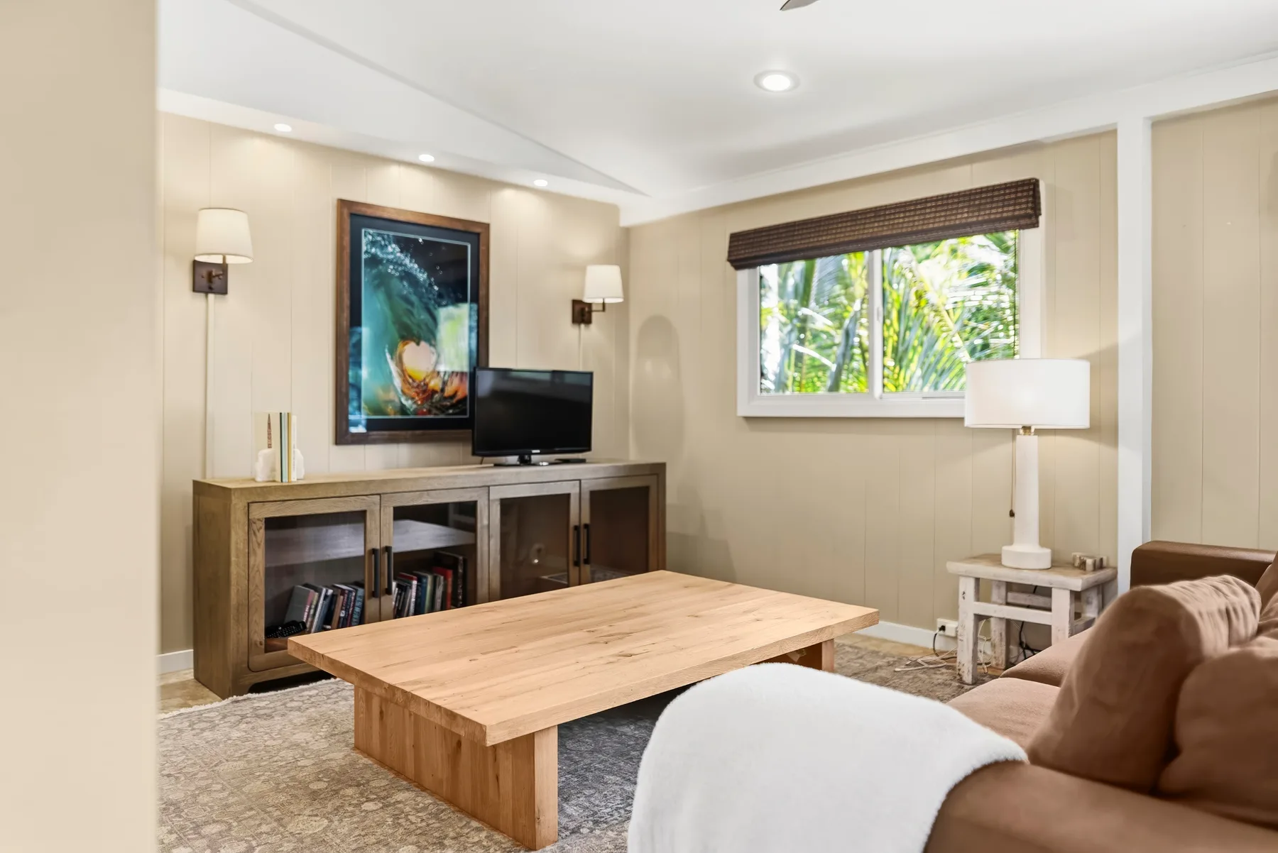 Una sala de estar con una mesa de centro de madera y un televisor.