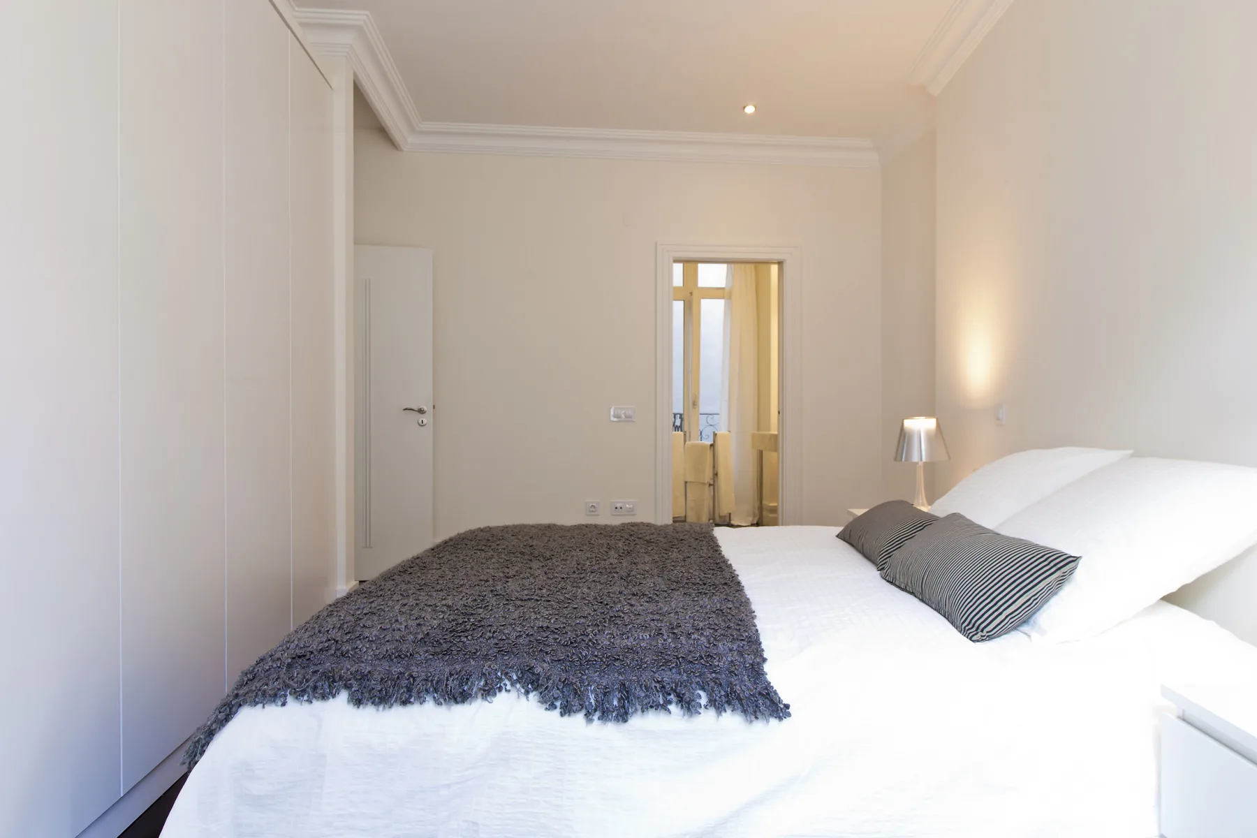 Bedroom with a bed and a dark textured blanket.