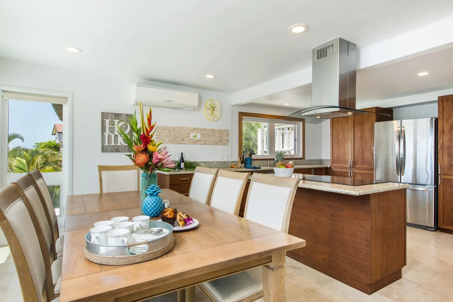 Una luminosa cocina y comedor con una mesa de madera e isla central.
