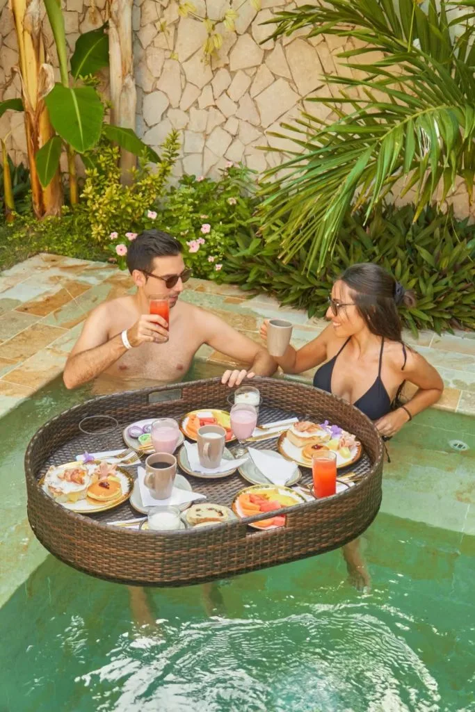 Guests enjoying breakfast by a pool