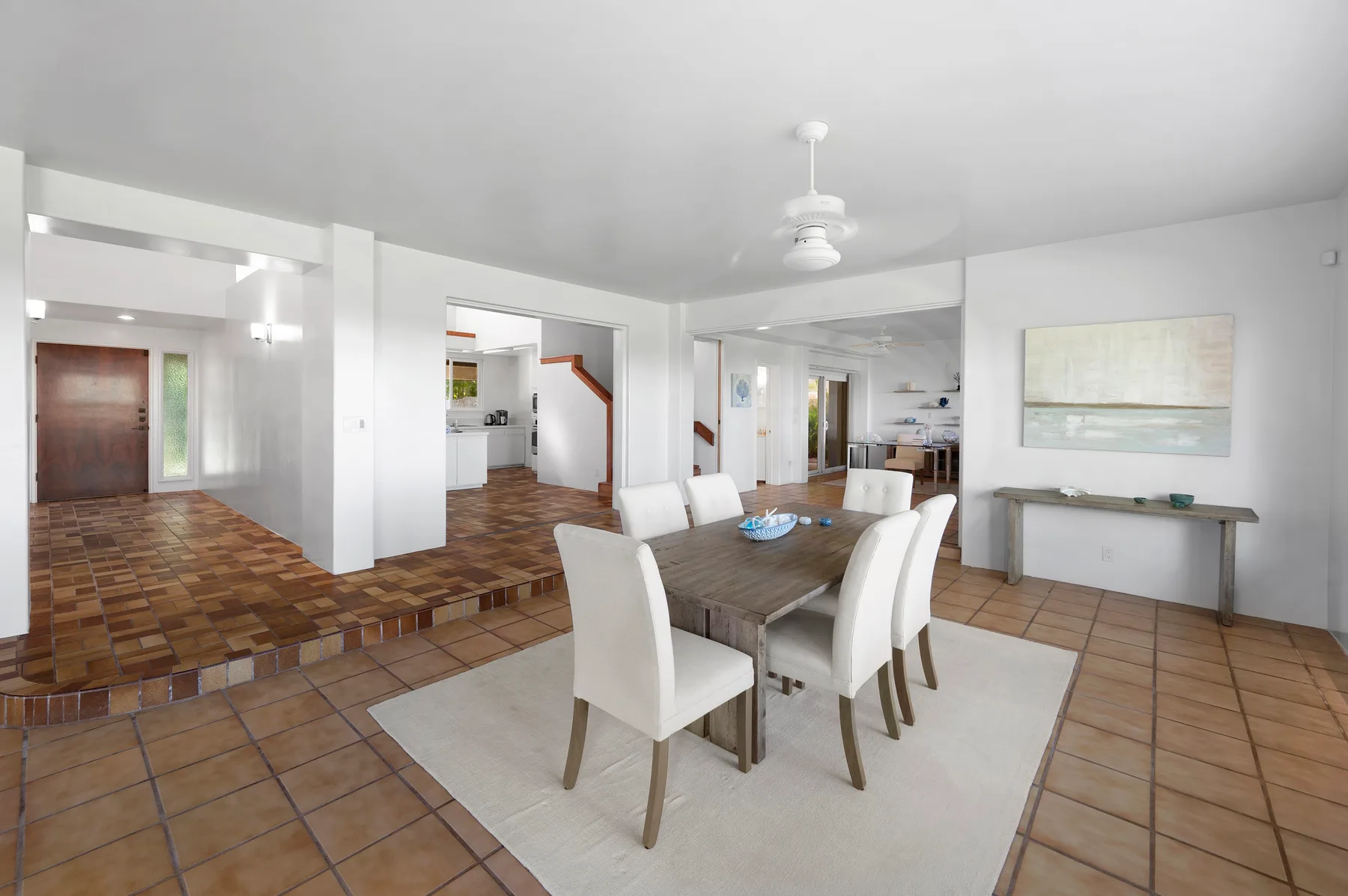 A dining area with a table and chairs beside an open kitchen.