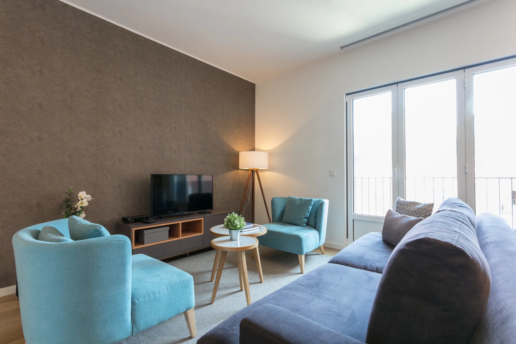 A living room with seating arranged around a television and coffee table.