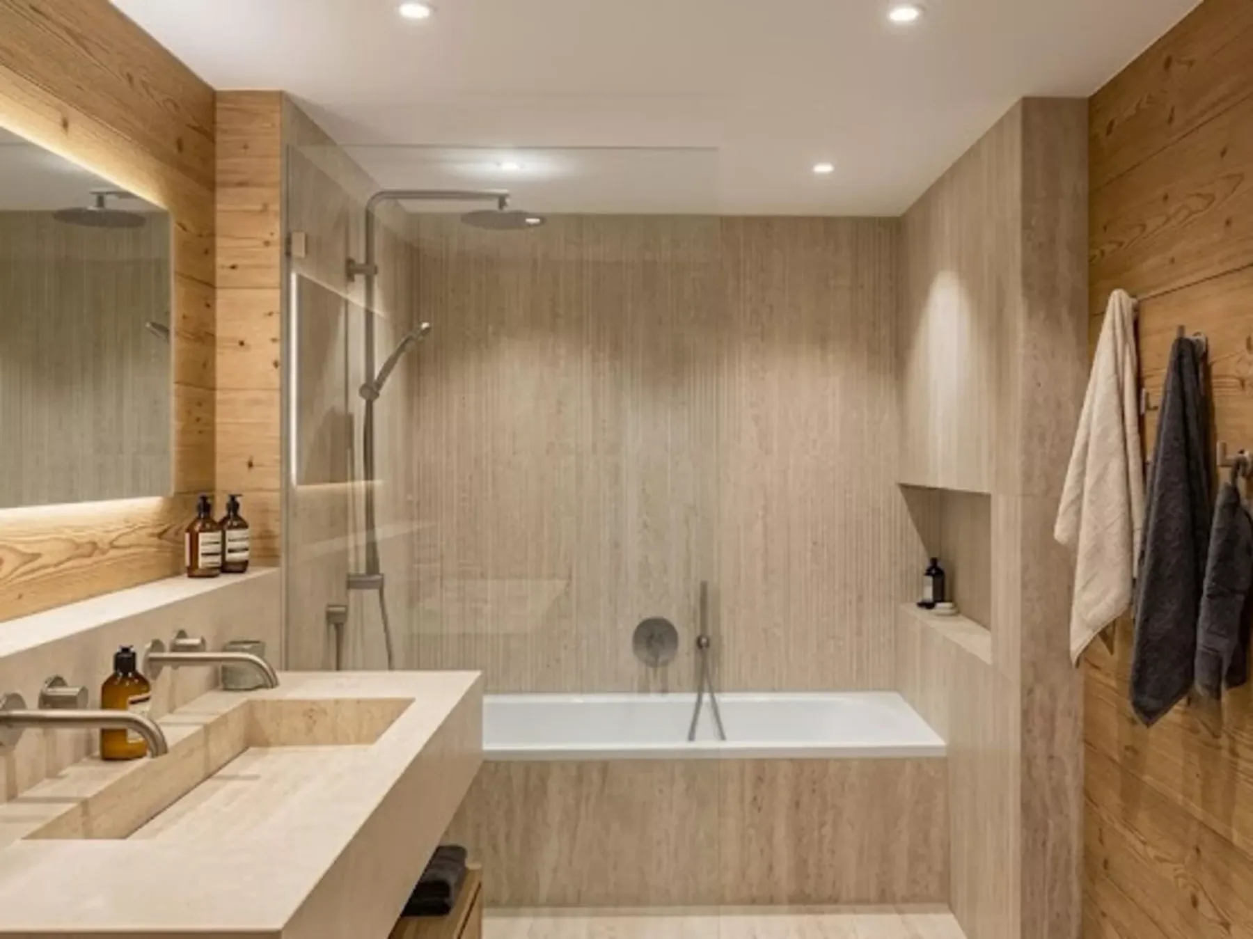 A bathroom with a bathtub, shower, and vanity.