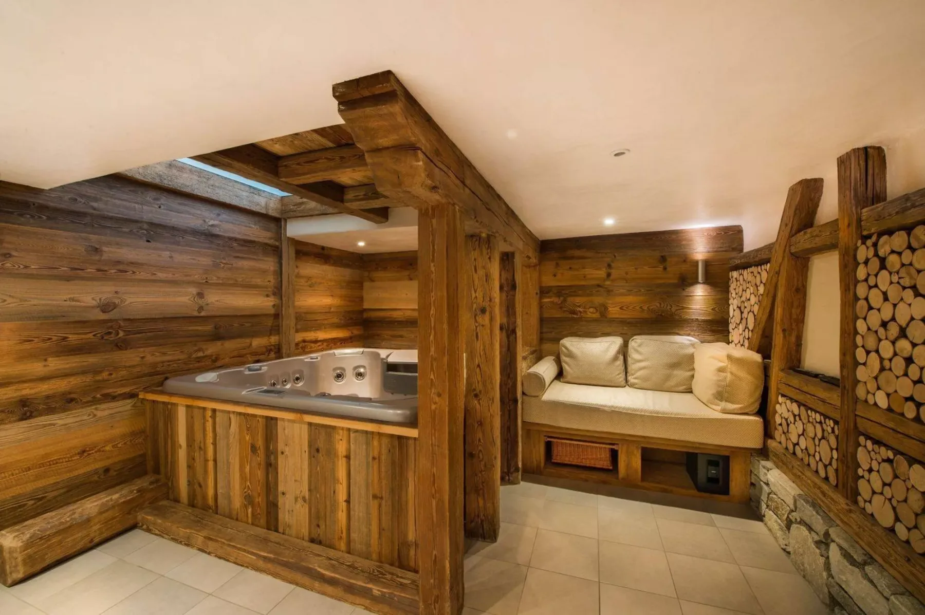 A wood-paneled spa room with a built-in hot tub and cushioned seating.