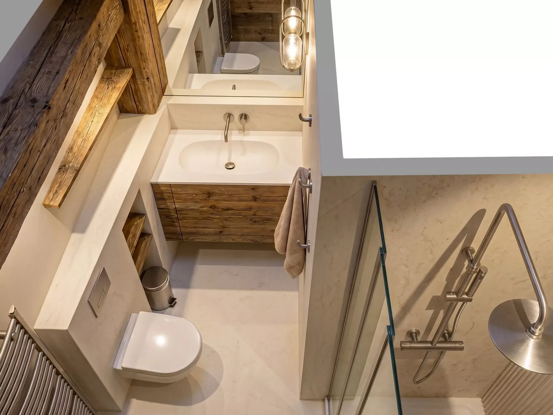 A bathroom with a sink, toilet, and glass shower.