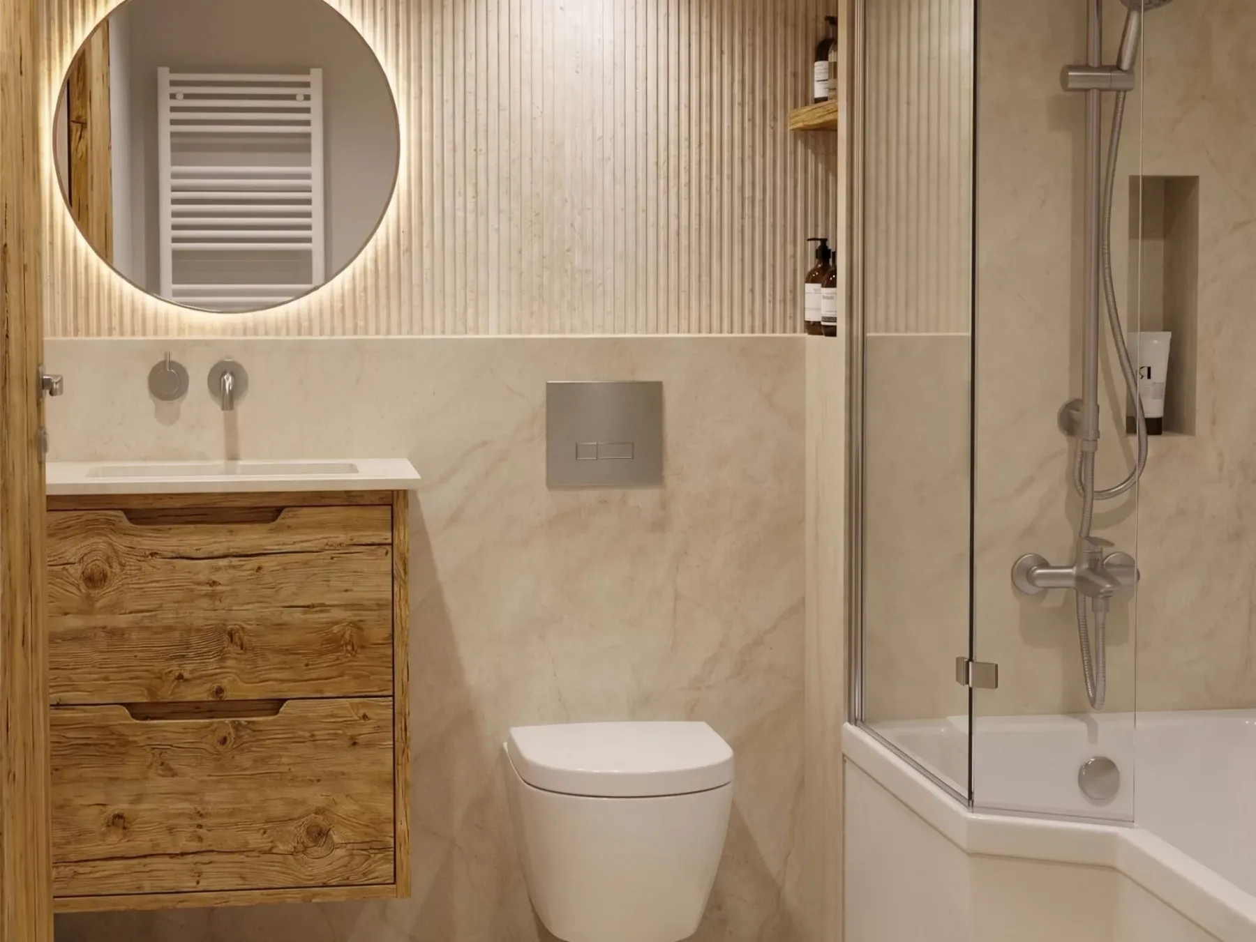 A bathroom with a wooden vanity, wall-mounted toilet, and glass shower.