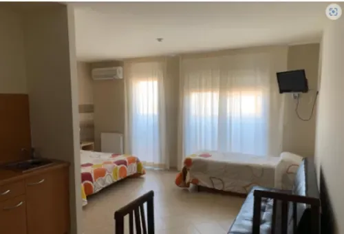 Family studio with two beds, TV, kitchen and balcony access