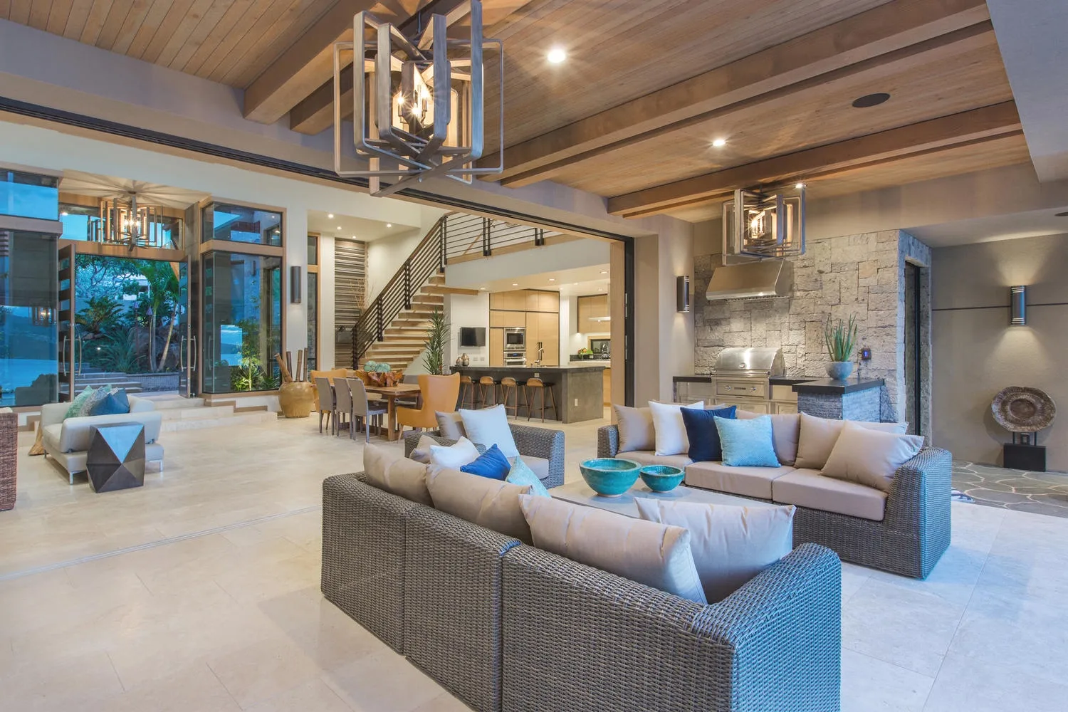 A spacious open-plan living area with seating beside a dining space and kitchen.