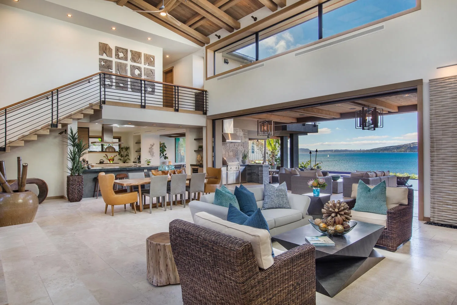A spacious living and dining area opens onto a patio overlooking the water.