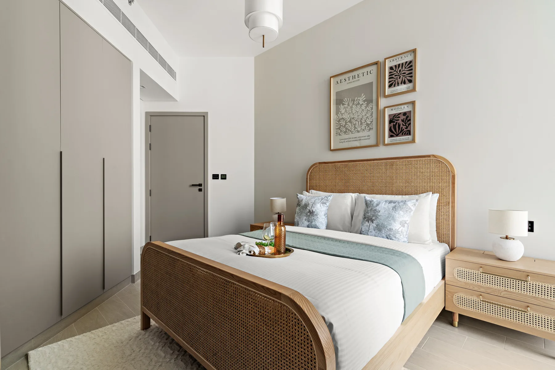 A bright bedroom with a woven headboard and neatly made bed.