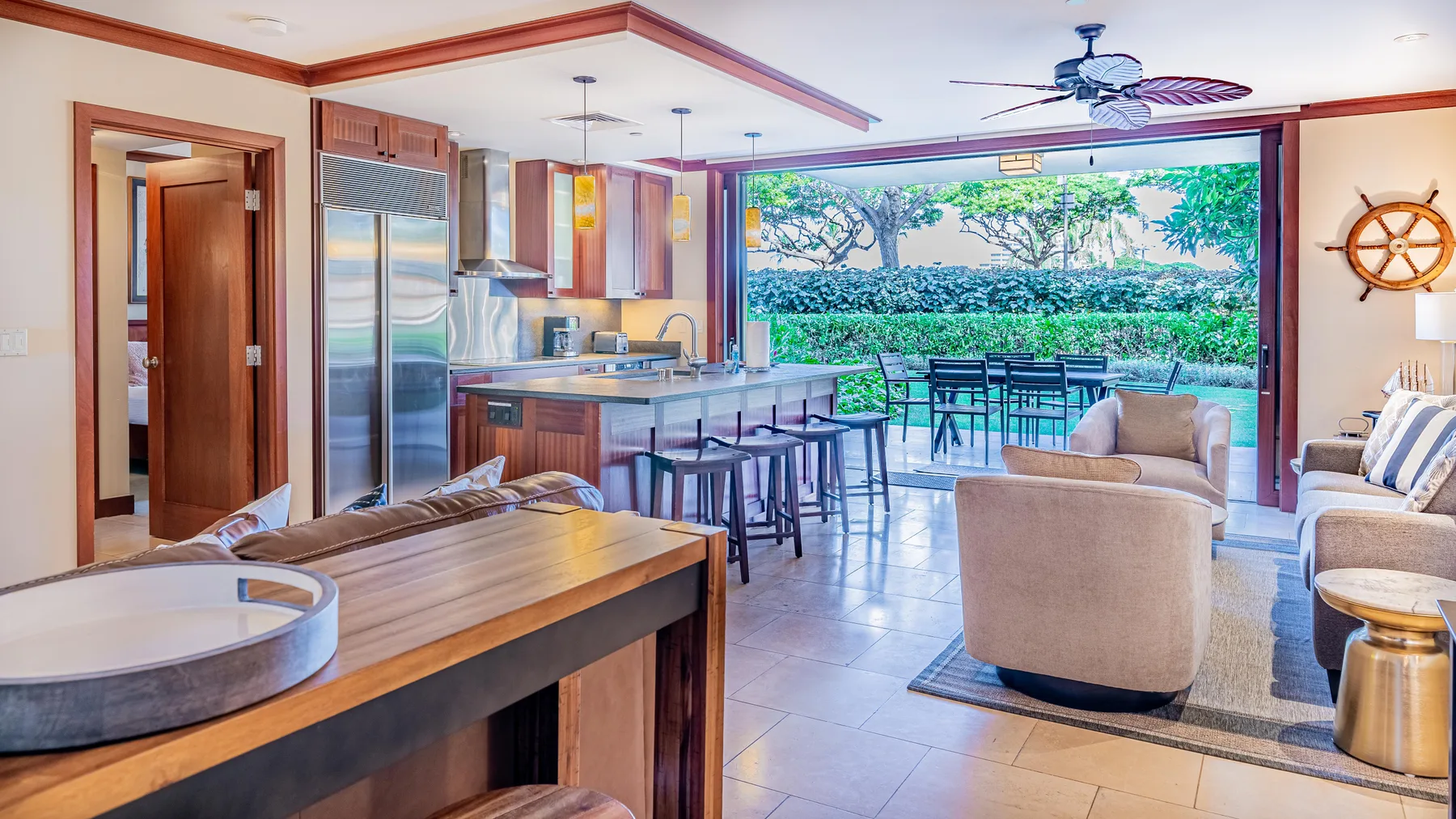 Una cocina y sala de estar de concepto abierto dan a un patio con comedor.