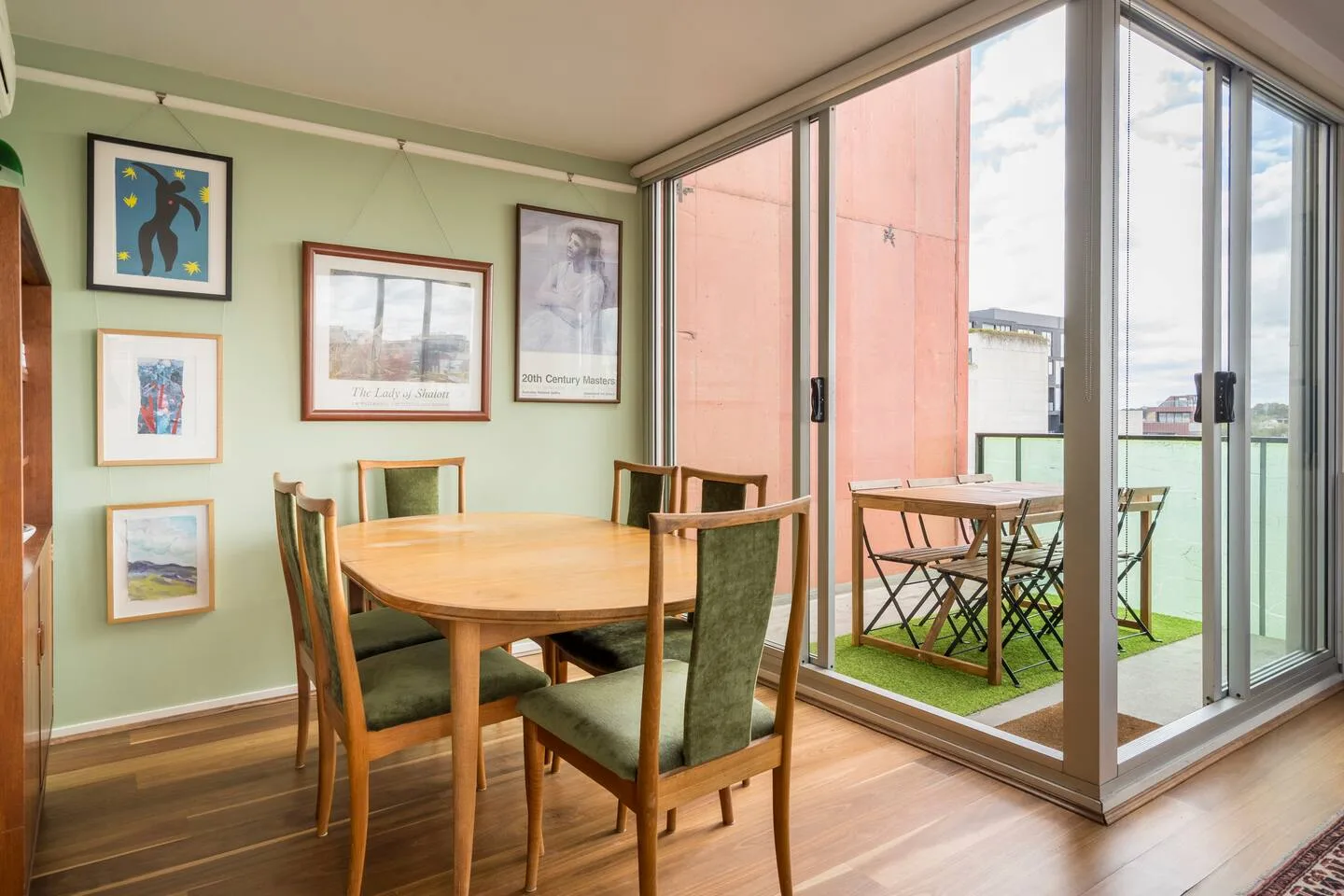 Share meals around the warm timber table, with sliding doors opening seamlessly to the balcony.