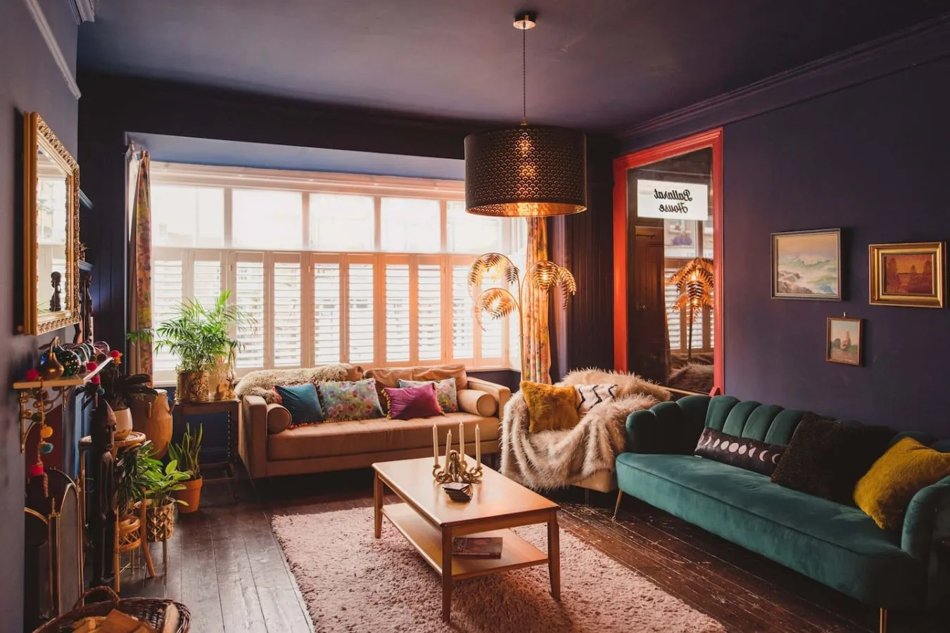 A living room with seating around a coffee table beside a large window.