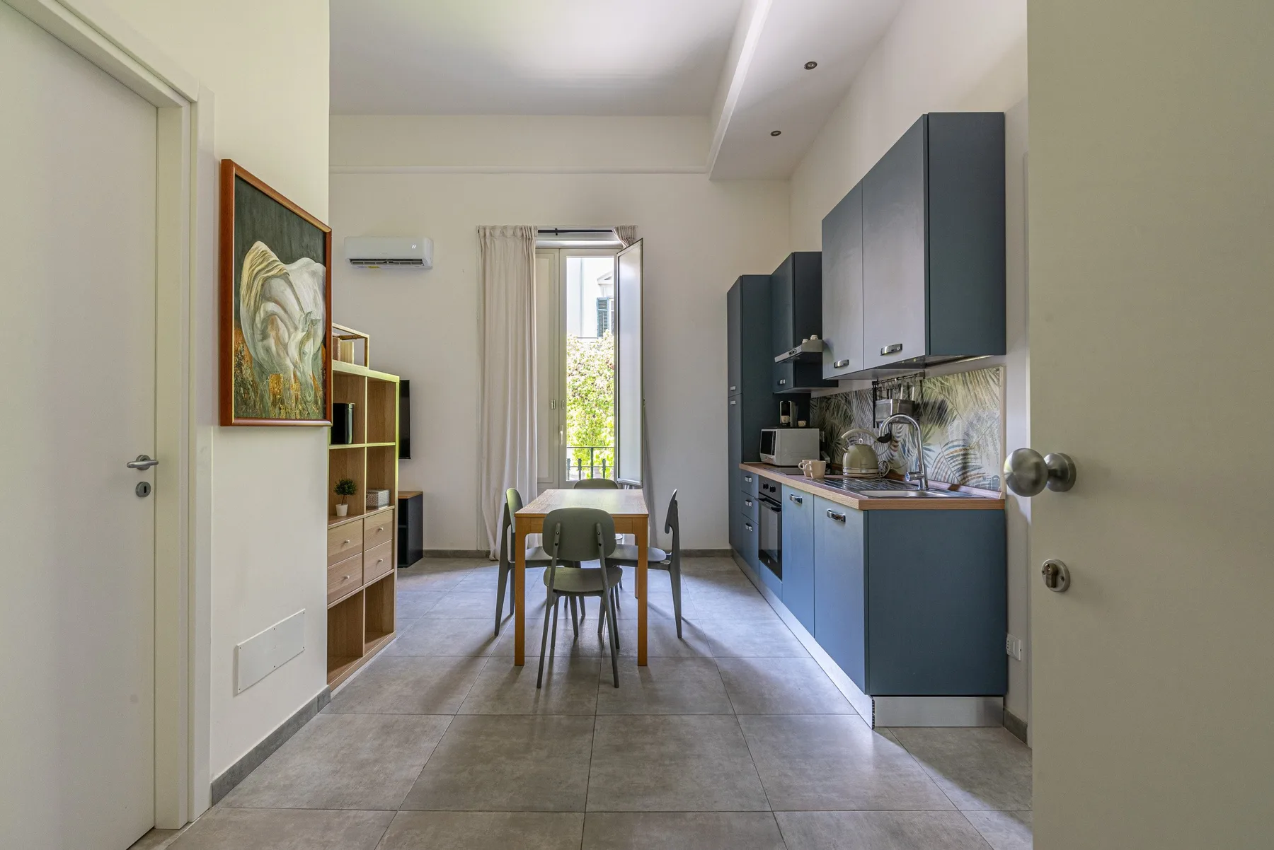 A compact kitchen with a dining table and cabinetry along the wall.