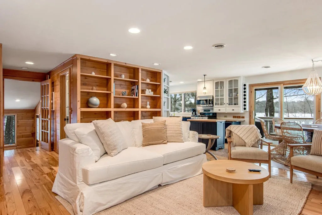 A bright living room with seating arranged around a round coffee table.