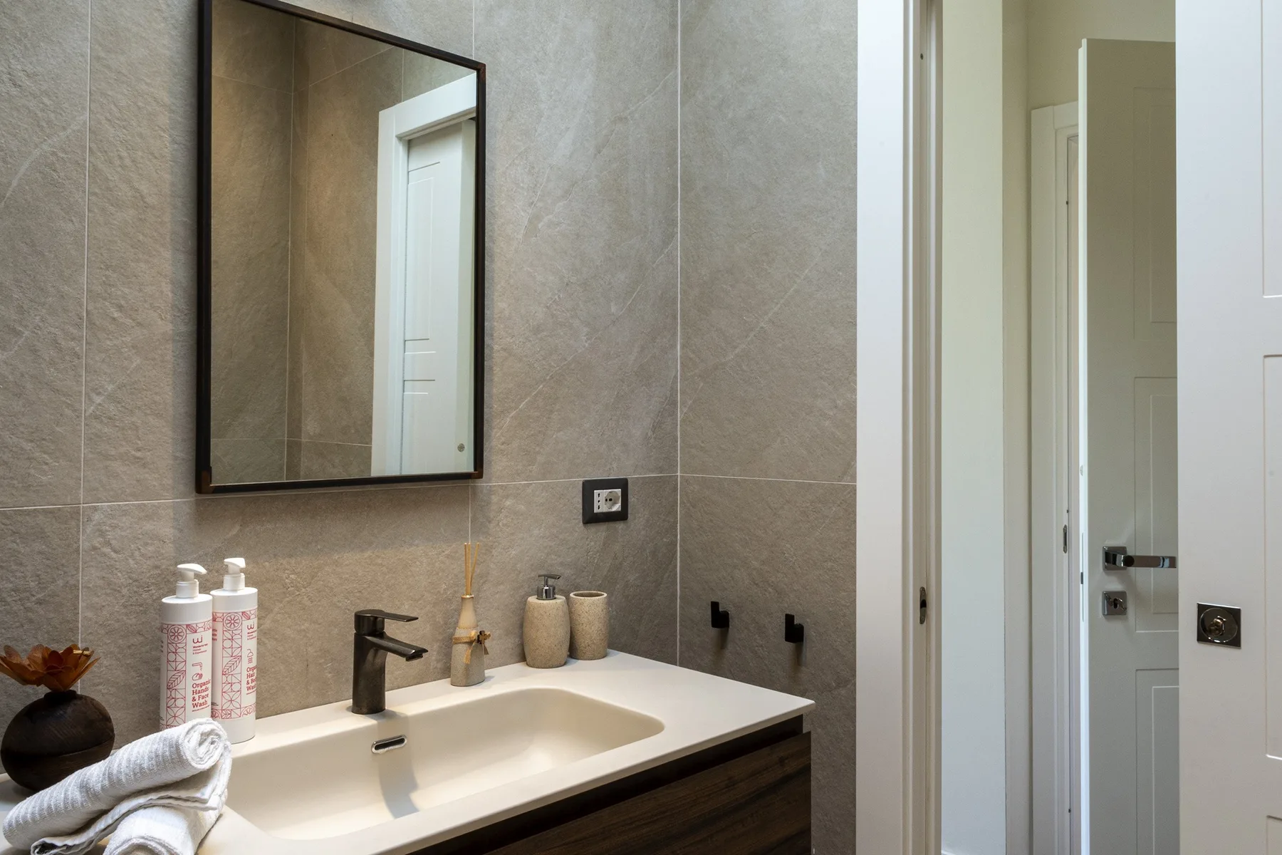 A bathroom vanity with a rectangular sink and wall mirror.