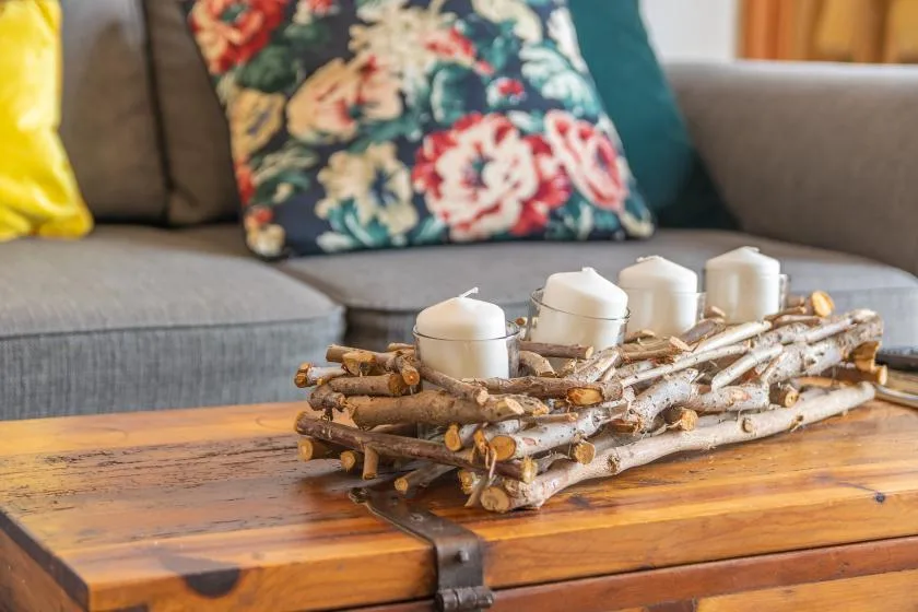 A living room seating area with a wooden coffee table and candles.